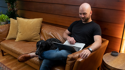 person using laptop on couch