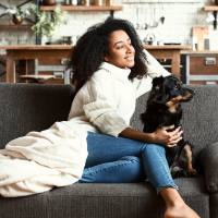 woman and dog cuddling on sofa