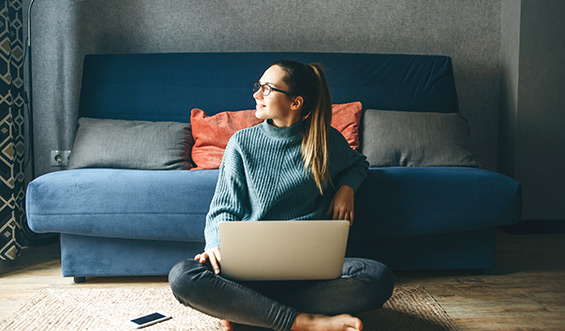 Girl working on laptop from home.