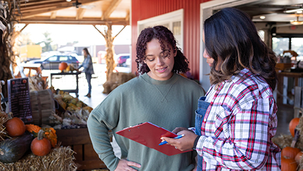 Two woman at vegetable stand