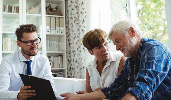 A senior couple talks with their financial advisor.