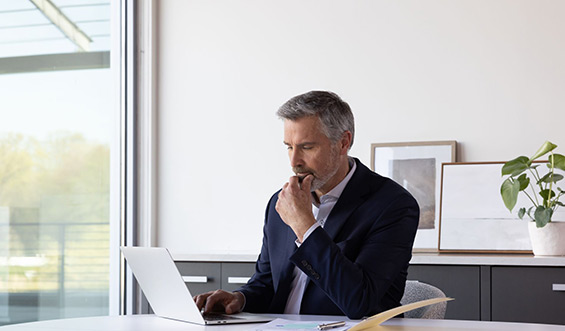 A man reads from his computer.