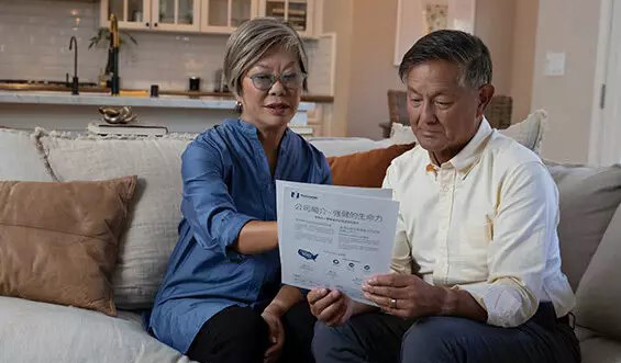 Two people looking at some papers together.