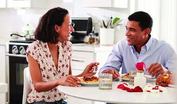 A couple sitting at the kitchen table.