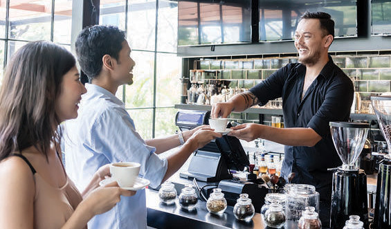 customer getting coffee in a shop