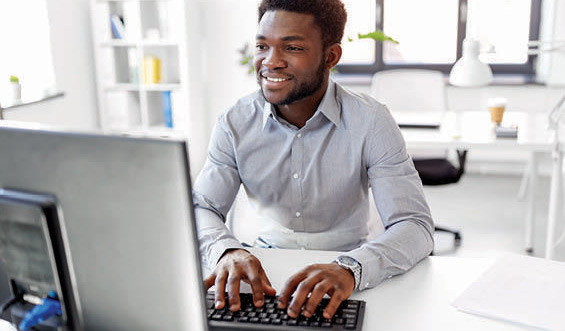 Man working on computer at desk.