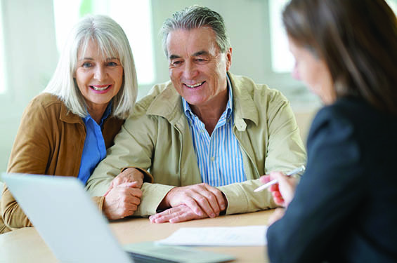 Couple looking at a documents with a financial professional