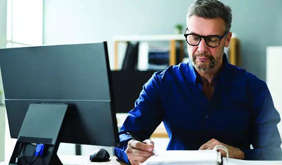 A man works at a computer.