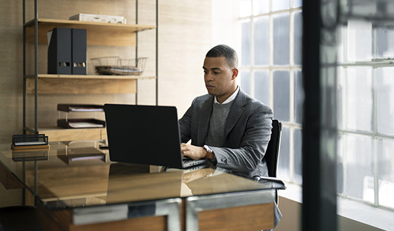 A professional working on a laptop.