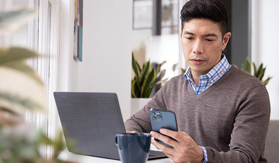 A man reading a news update on his phone.