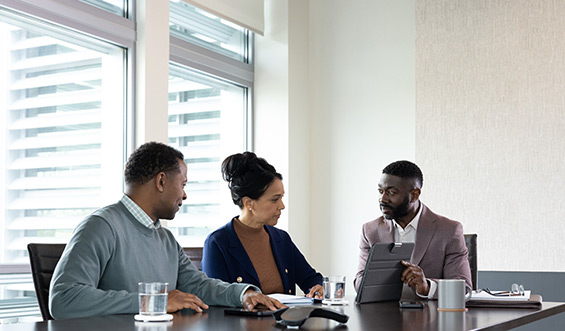 Coworkers meet in a conference room.