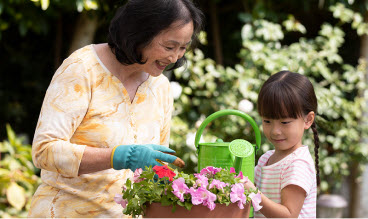 older woman and young girl with flowers