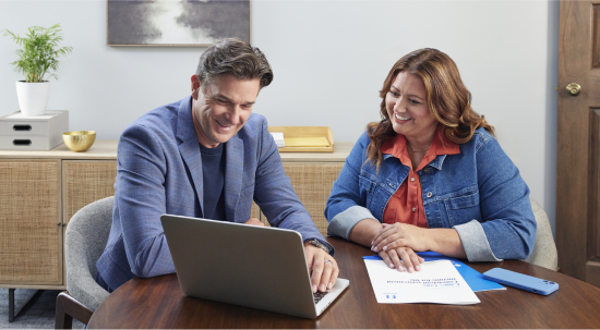 woman sitting with a financial professional looking at a laptop