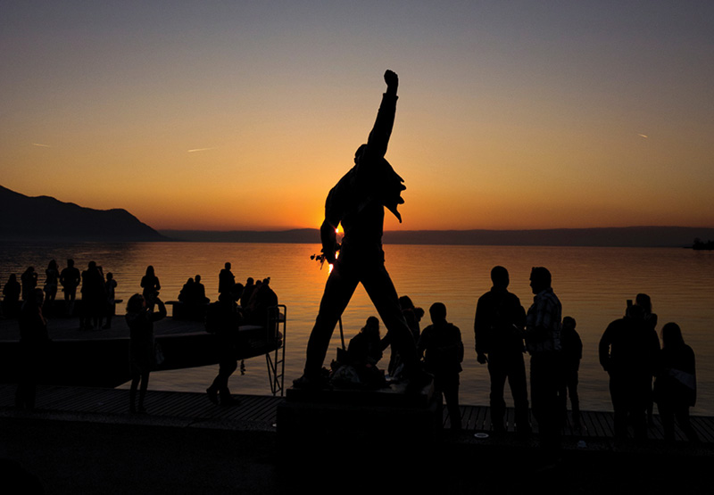 A statue of Freddie Mercury stands along Lake Geneva.