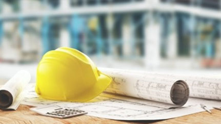 construction helmet and blueprints