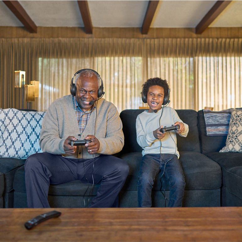 grandfather playing video games with grandson