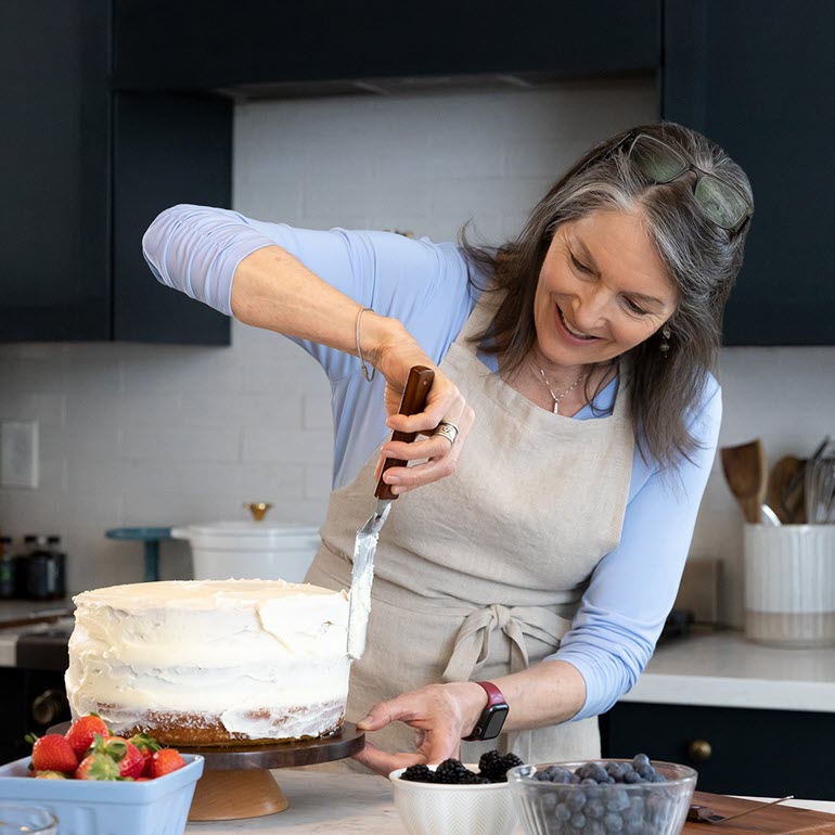 woman icing a cake